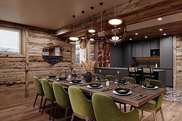 A dining room with a long table and green chairs