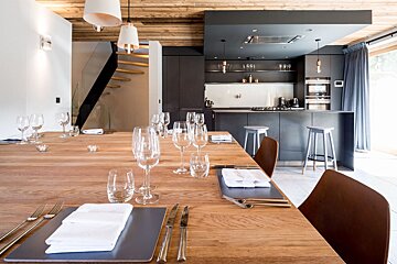 A kitchen with a wooden table and glasses on it