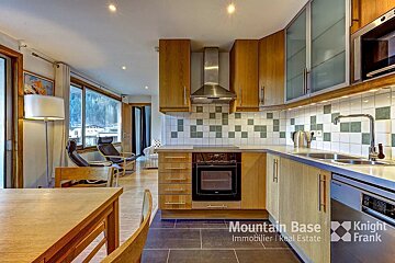 A kitchen with wooden cabinets and stainless steel appliances is for sale by mountain base