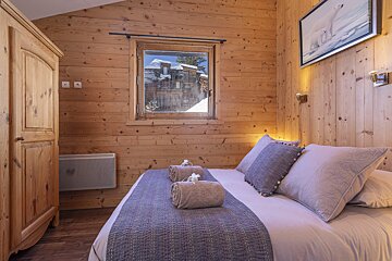 A bedroom with a bed and a picture of a polar bear on the wall