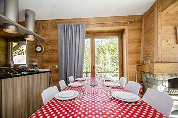 A kitchen with a red and white polka dot table cloth