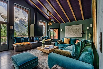 A living room with a blue couch and a purple ceiling
