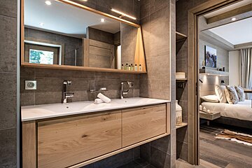 A bathroom with two sinks and a large mirror