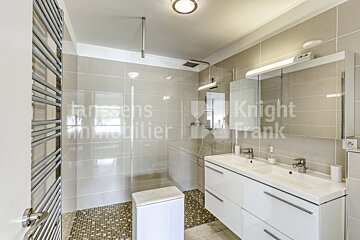 A bathroom with knight frank written on the wall