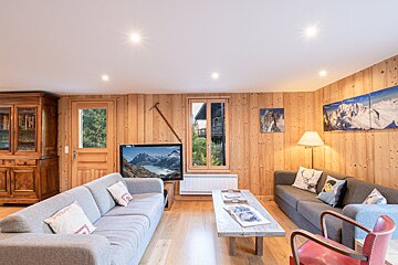 A living room with two couches and a flat screen tv