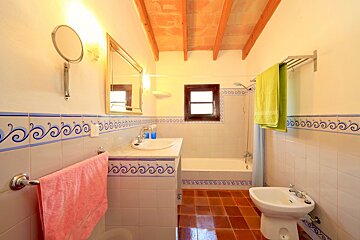 A bathroom with a blue and white tile border