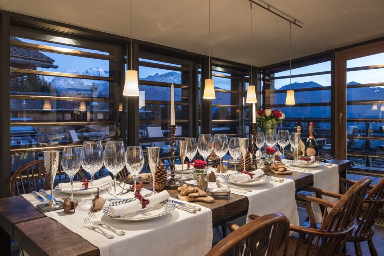 A table set for a dinner with a mountain in the background