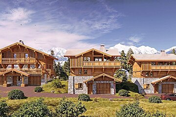 Row of alpine chalets with wood and stone facades on green hills, backed by majestic snow-capped mountains under a clear blue sky.