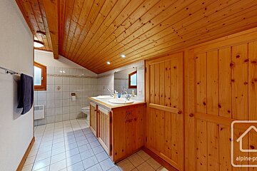A bathroom with two sinks and a sign that says alpine-pro