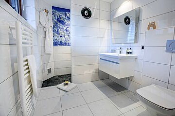 A bathroom with the number 6 on the wall