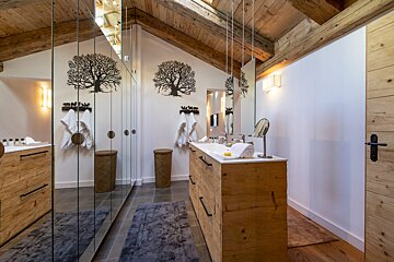 A bathroom with two sinks and a mirror