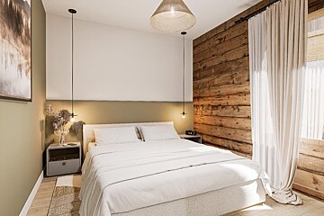 A bedroom with a wooden wall and a bed