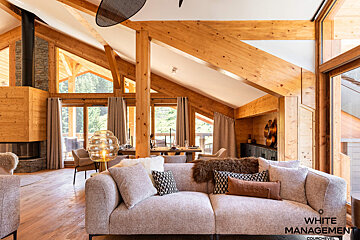 A kitchen with white cabinets and a stainless steel refrigerator