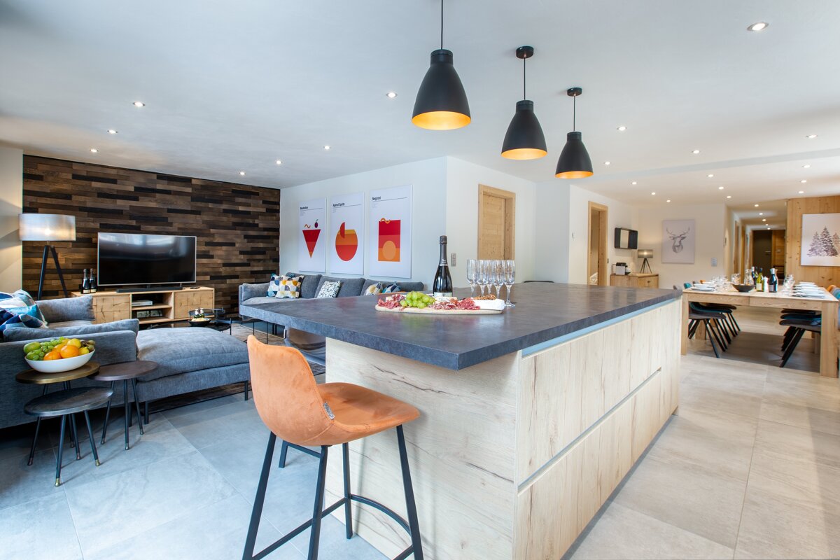 A kitchen with a bottle of wine on the counter