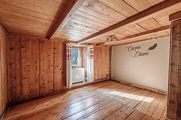 A room with wood paneling and carpe diem written on the wall