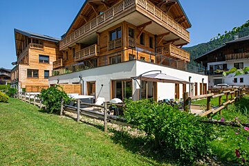 A large house with a hot tub in the backyard