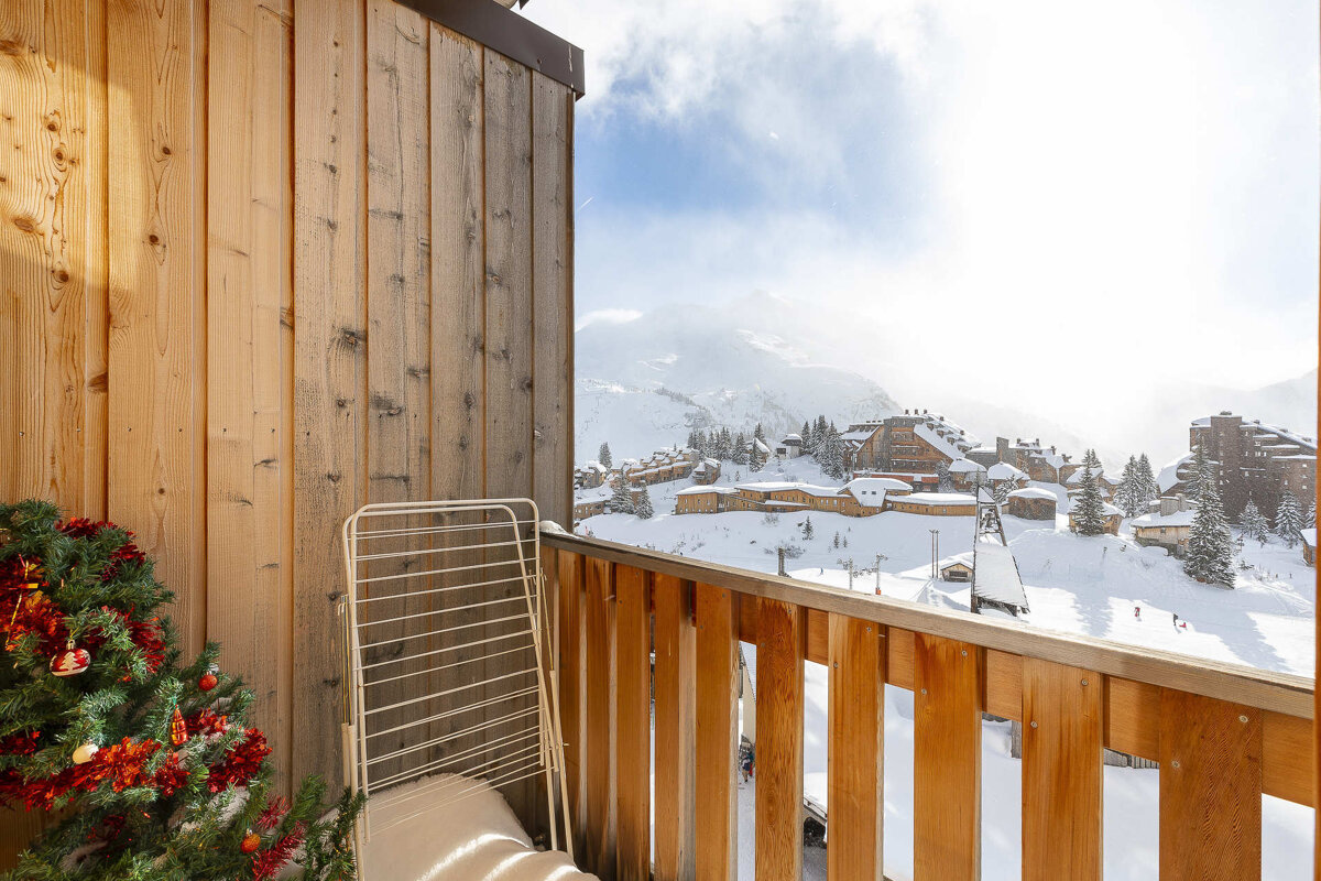 A wooden balcony with a christmas tree on it