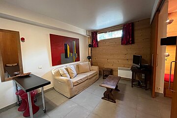 A living room with a couch a table and a television