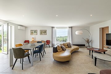 A living room with a couch a table and chairs