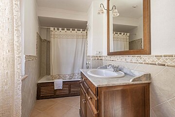 A bathroom with a sink a mirror and a bathtub