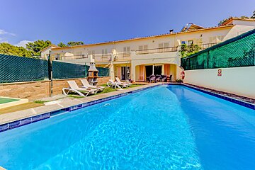 A swimming pool in front of a house with a no diving sign