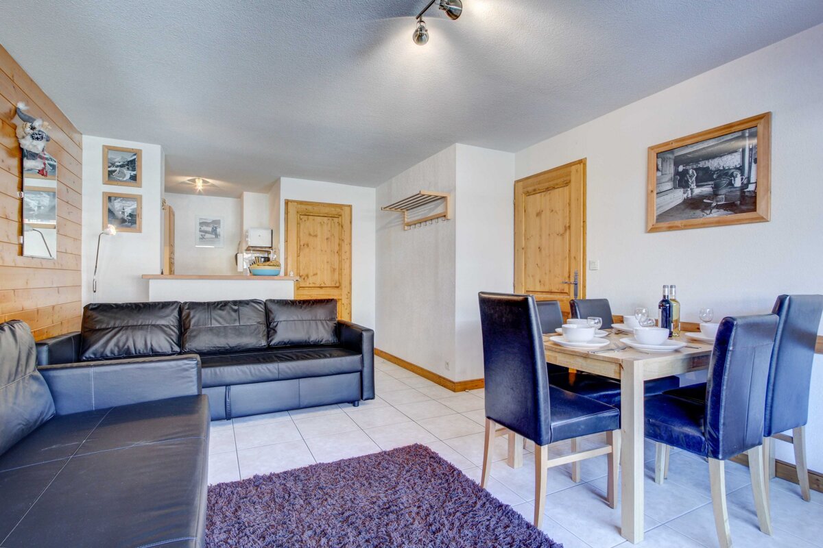 A living room with a couch a table and chairs