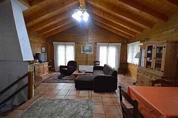 A living room with a couch a chair and a television