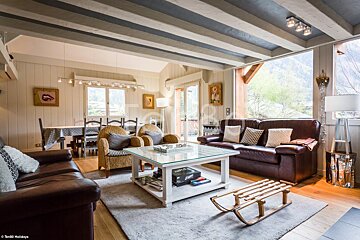 A living room with a brown couch and a white coffee table