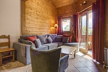 A living room with a couch and two chairs