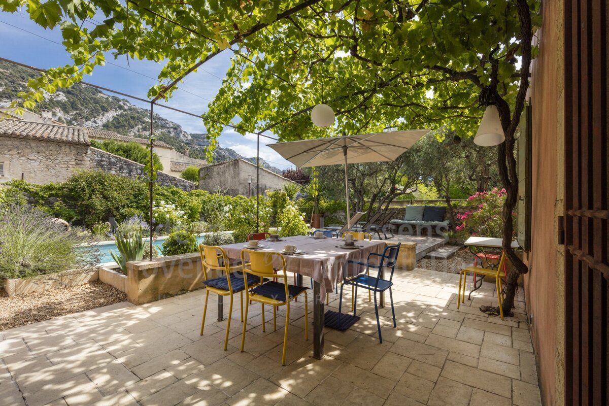 A patio with a table and chairs under an umbrella and a sign that says ' provence ' on it