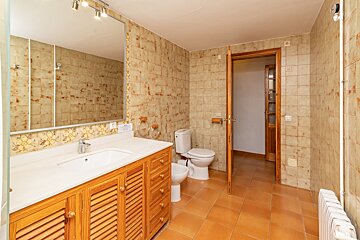 A bathroom with a sink toilet and mirror