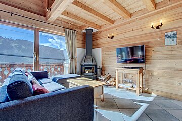 A living room with a fireplace and a flat screen tv