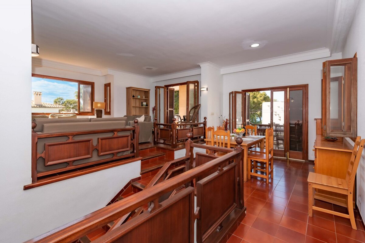A living room with a staircase leading up to the second floor