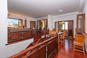 A living room with a staircase leading up to the second floor