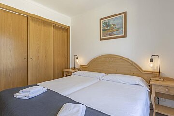 A bedroom with two beds and a window