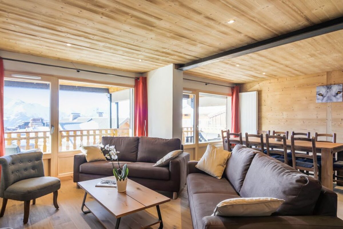 A living room with a couch a chair and a table