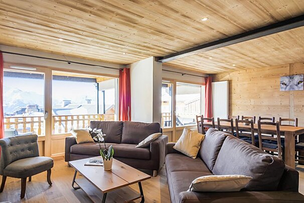 A living room with a couch a chair and a table