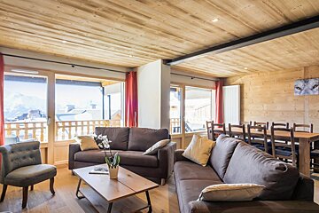 A living room with a couch a chair and a table