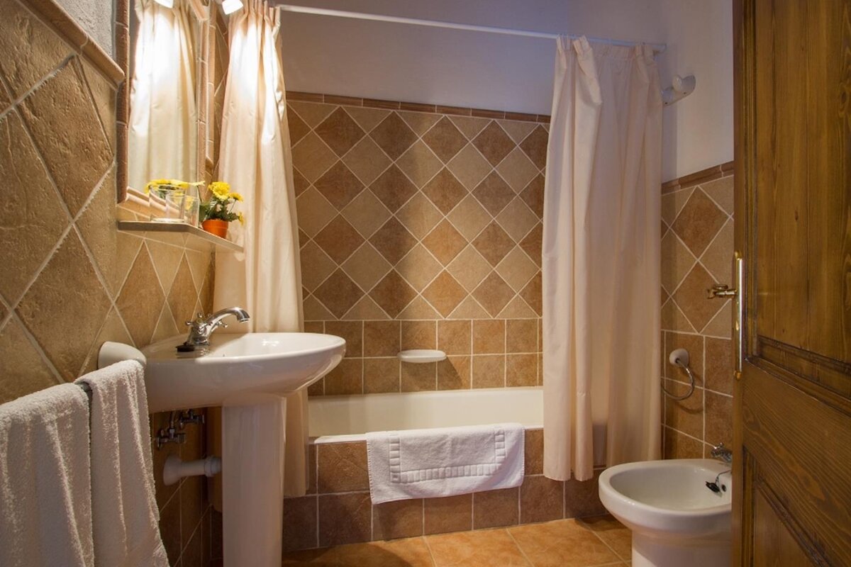 A bathroom with a sink a toilet and a bathtub