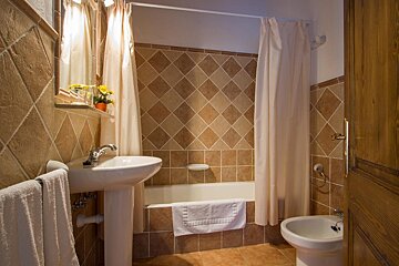 A bathroom with a sink a toilet and a bathtub