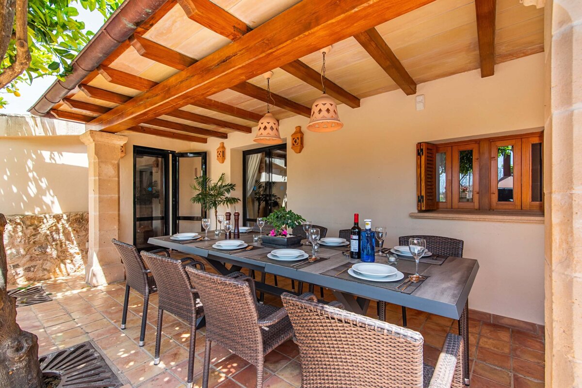 A table with plates and a bottle of wine on it