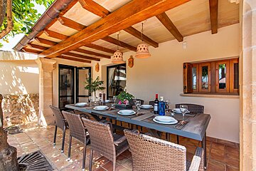 A table with plates and a bottle of wine on it