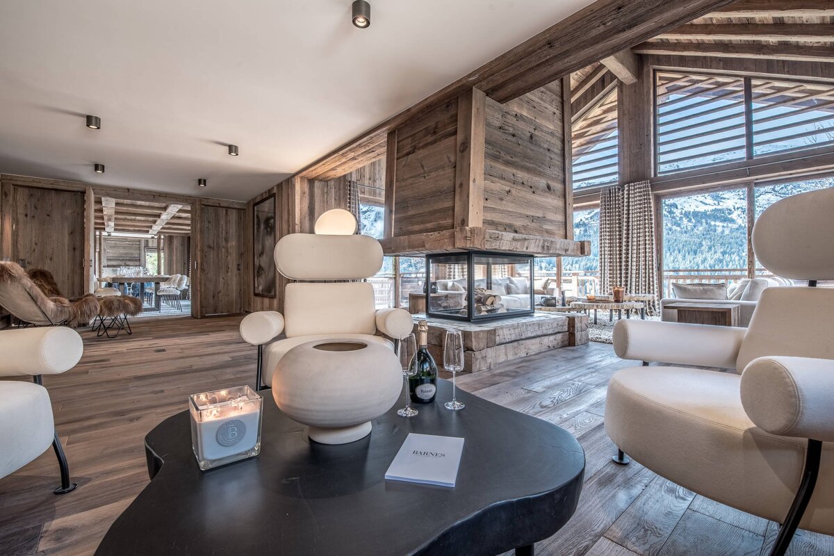 A bottle of champagne sits on a table in a living room