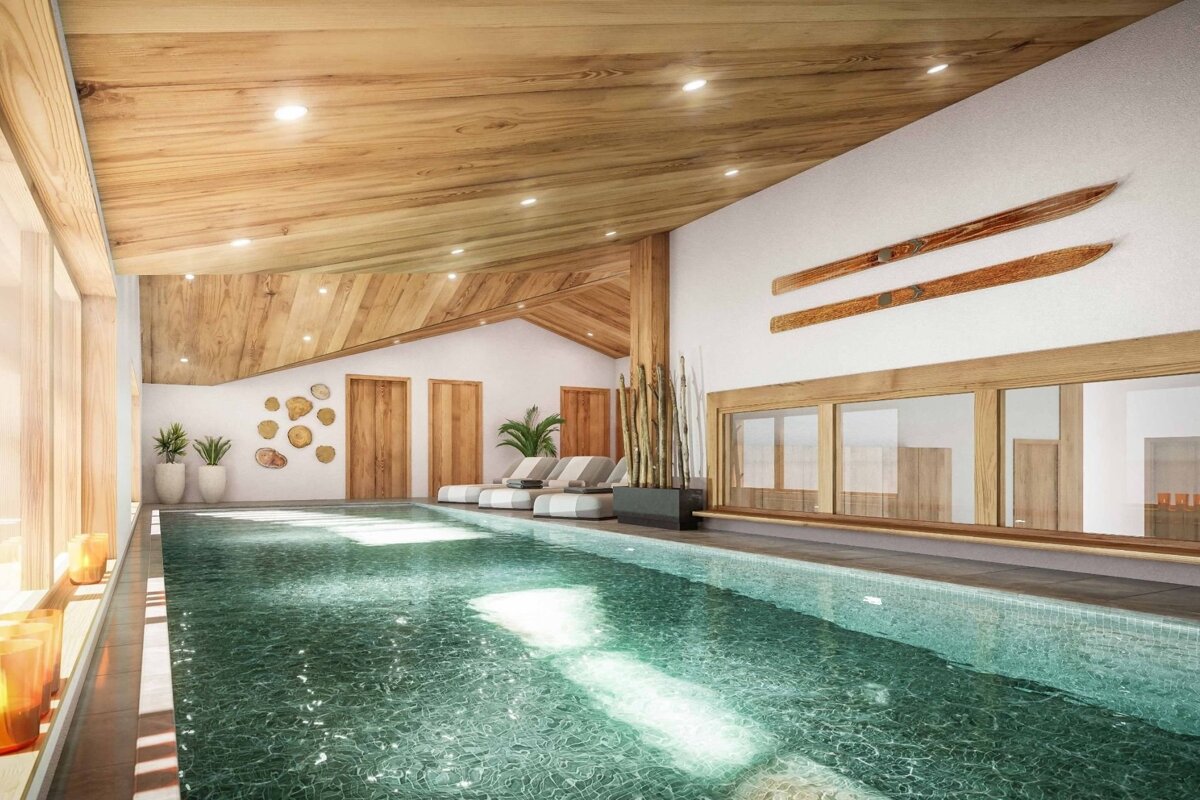 A luxurious indoor pool featuring a wooden ceiling, comfortable lounge chairs, and alpine-style decor with wooden skis on the wall.