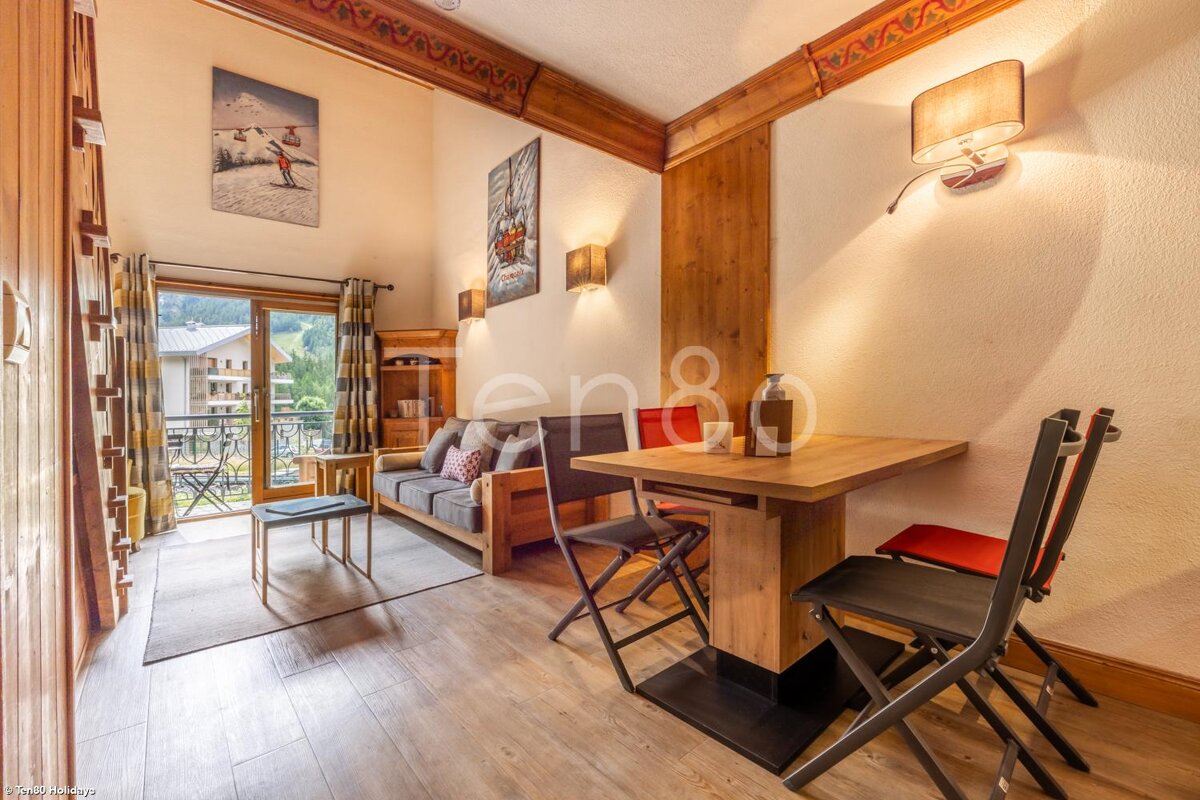 A living room with a couch and a table with the number 80 on the wall