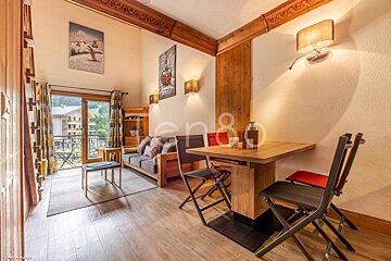 A living room with a couch and a table with the number 80 on the wall