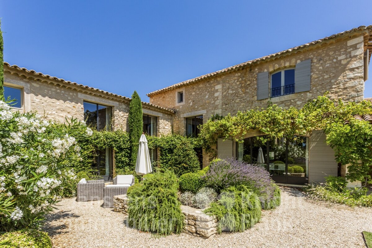 A large stone building with a patio in front of it