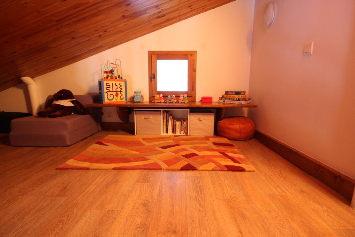 A corner of a room with toys and a board that says 5128 on it