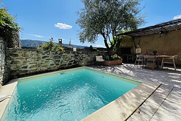 A small swimming pool in the backyard of a house