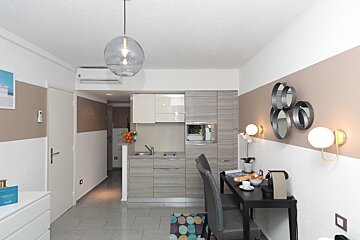 A small kitchen with a table and chairs in it